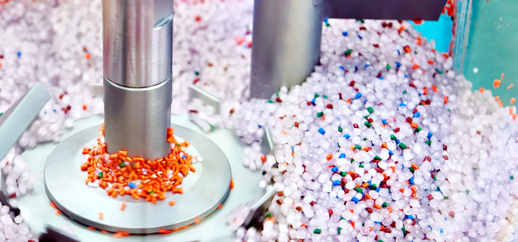 Thermoplastic resin pellets being processed in an industrial drying system, illustrating material preparation and moisture‑control techniques for efficient thermoplastic drying.